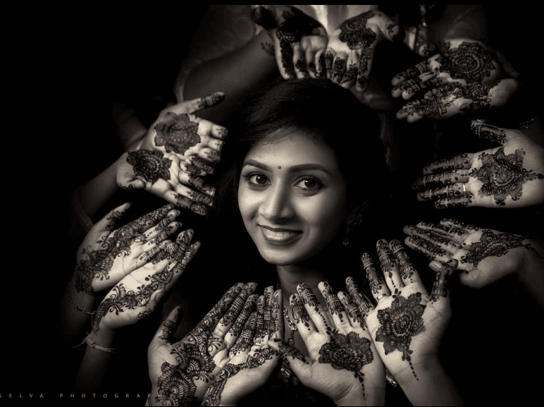 Selva Photography portrait with intricate henna hands surrounding the subject